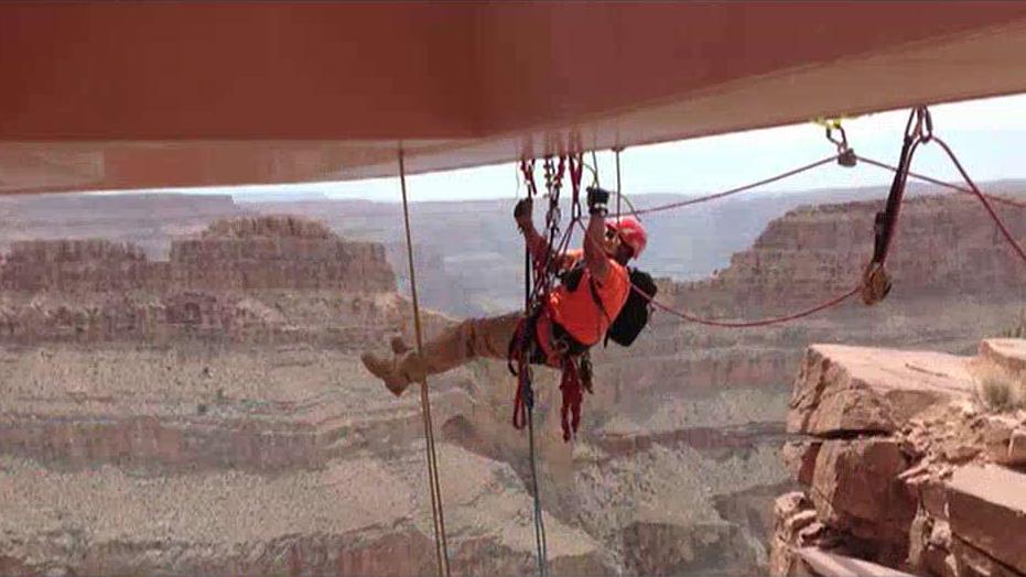 Abseilon USA CEO Kenneth Piposar and Abseilon USA Rope Access Technician Casey Gilmore on the challenging job of cleaning the Skywalk, thousands of feet above the Grand Canyon in Arizona.