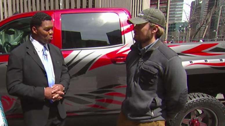 NFL legend Herschel Walker and veteran Brian Jason on the truck Brian won as part of the Rocky Ridge Trucks' 'The True American Hero Truck Giveaway.'