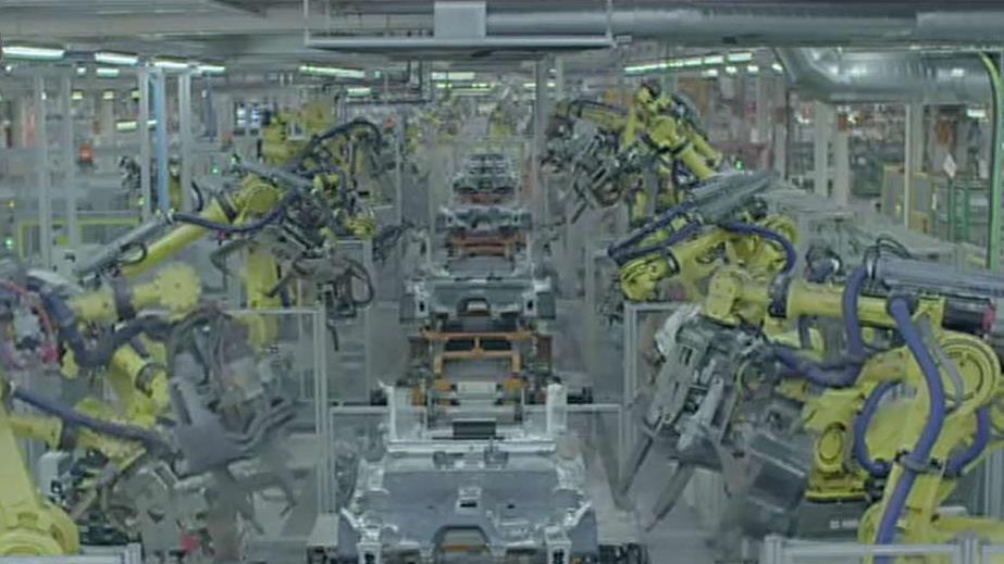 FBN's Charles Payne on Spanish automaker SEAT showing off how the robots in its factory work together to build cars.