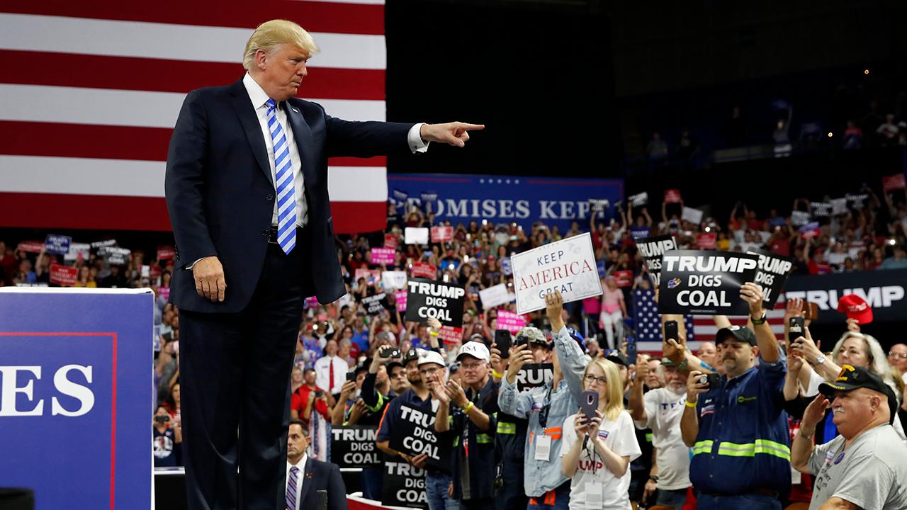 President Donald Trump touts U.S. job growth during a Make America Great Again Rally in Charleston, West Virginia.