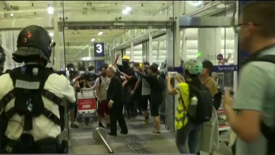 Thousands of protesters swarmed the Hong Kong airport for a second day.