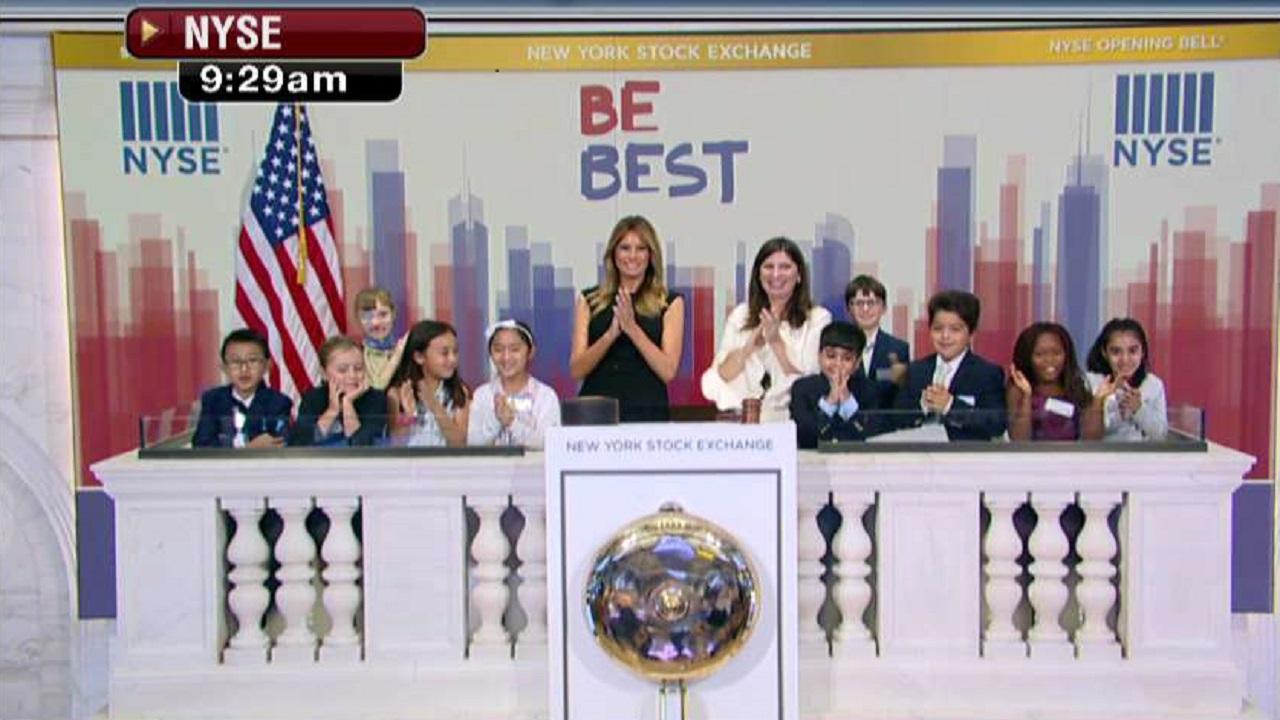 Melania Trump rings the opening bell at the New York Stock Exchange with children from the United Nations International School.