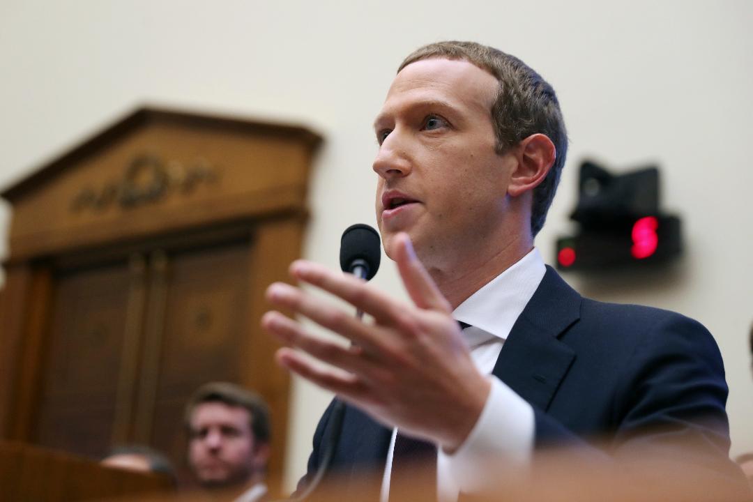 CEO Mark Zuckerberg says when content is flagged by users or Facebook software it can be placed into a queue for review. 
