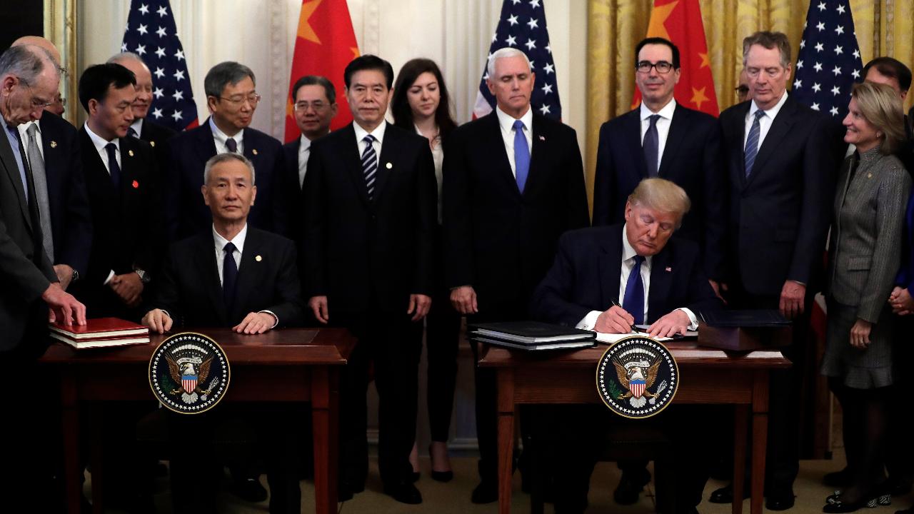 President Trump and Vice Premier Liu He sign the US-China trade agreement.
