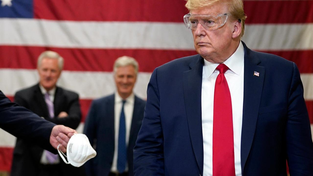 Trump says the head of Honeywell gave him permission to take the mask off after wearing one briefly during his visit to the company's Arizona plant on Tuesday. 